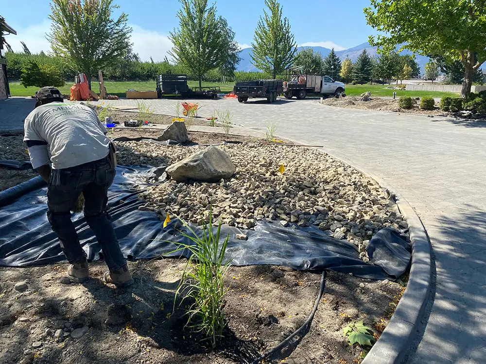 Emerald Irrigation crew preparing undercloth for xeriscaping