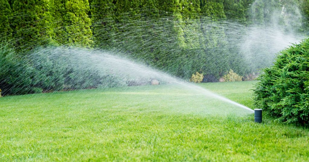 irrigation systems sprinklers on and watering the lawn